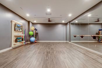 a play room with mirrors and toys on the wall
